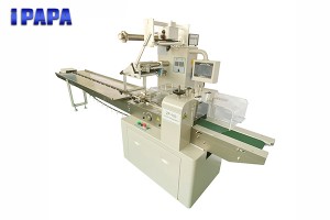 Horizontal flow packing machine